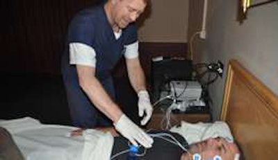 A technican for Sleep Pointe at Prime Inc.'s off-site sleep lab in Springfield, Mo., shows how he readies a patient for sleep apnea testing. (Photo Randy Grider)