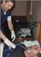 A technician for Sleep Pointe in Prime Inc.'s offsite sleep lab in Springfield, Mo., prepares a patient for sleep apnea testing.
