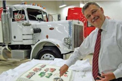 Peterbilt General Manager Bill Jackson cuts the company's 70th anniversary cake at the Denton, Texas, plant. The white Model 359 was the first truck off the plant's assembly line when it opened 29 years ago.