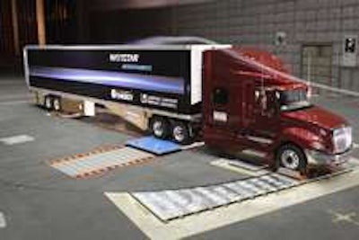 A smoke stream glides over a Navistar ProStar truck and trailer during Lawrence Livermore National Laboratory testing at the NASA Ames Center in California. (Credit Lawrence Livermore National Laboratory)