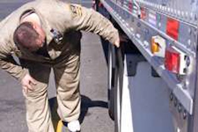 An Oregon Department of Transportation inspector checks tires during a truck inspection. (Courtesy Oregon Department of Transportation)