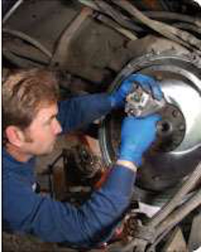 A technician works on a clutch at Western Truck Parts in Henderson, Colo. Clutch failure is among the problems that can result from a faulty crankshaft damper.