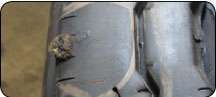 Truck tire repairs must not be done with rope type material as it cannot contain the inflation pressures for such tires. This repair was made in the shoulder of the tire, which is not fully reinforced by belts. Air leaked in around the repair and separated the cords, resulting in a potential for catastrophic failure.