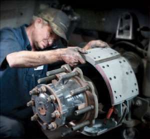 Kirk Beckham performs brake work at Southland International Trucks in Tuscaloosa. Preventive maintenance scheduled at home costs much less than emergency work on the road.