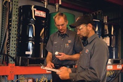 Technicians take a field test sample of Kendall Super DXA with liquid titanium, one of the more recent and advanced diesel engine oil additives.