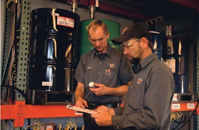 Technicians take a field test sample of Kendall Super DXA with liquid titanium, one of the more recent and advanced diesel engine oil additives.