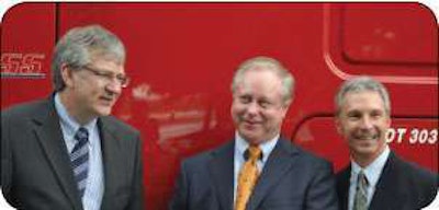 Martin Daum, left, and Mark Lampert, right, of Daimler Trucks North America, delivered the 50,000th Freightliner purchased by Max Fuller, co-chairman and CEO of U.S. Xpress.