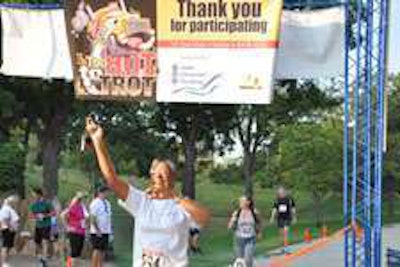 Lily Williams of Chaparral, N.M., finishes the Too Hot to Trot 5k as part of the Health, Safety & Wellness activities at the Great American Trucking Show.