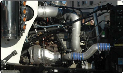 On this DD16 that equips Bob Berry’s wrecker, the aluminum heat shield (just above the frame rail on the left) covers the turbo-compounding turbine.