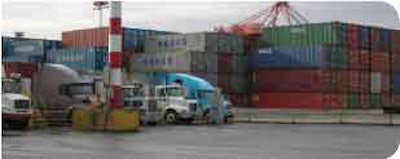 Next to decks of container boxes, intermodal truckers wait to be checked in at a Port of Seattle terminal.