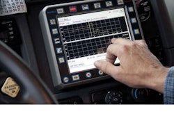 A U.S. Xpress driver calls up information on his dash-mounted EOBR, which the carrier plans to make available companywide.