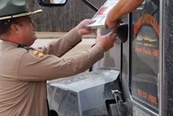 Manchester Scales — Johnny McBee checks a logbook