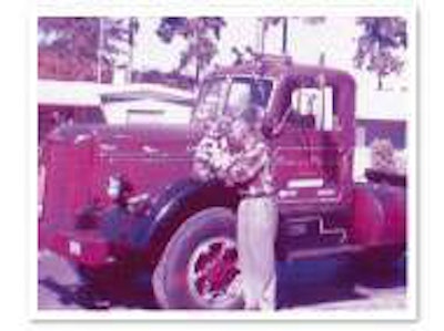 Produce hauler patriarch Ed Kimball holds his son Kevin in the late 1950s, atop his LJ Mack in St. Petersburg, Fla.