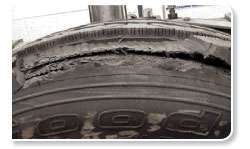 Tread damage (left) and casing damage that exposes fabric (right) do not have to be this severe to merit an out-of-service order.