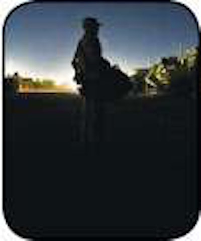 U.S. Air Force Sergeant and convoy commander David Perez of the 70th Medium Truck Detachment walks through the armed forces equivalent of a truck stop after completing a successful first leg of a seven-day convoy Oct. 22.