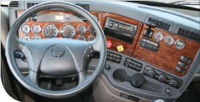 A full complement of gauges in the wood-grain dash includes the combination fuel and diesel-exhaust-fluid gauge. On the wing dash is a fuel economy gauge. Also, additional HVAC vents are there to complement those directly ahead of the driver for good ventilation and cooling. In the sleeper, doors cover the storage closets for a clean look. There are openings for the TV and microwave, with 120-volt outlets.