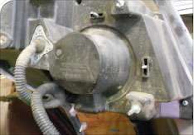 Many lamps must be adjusted from under the hood. On this International, the under-hood vertical adjustment is above the lamp, and the horizontal to the right. The screws have hex heads.