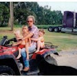 Dedication to family parallels work ethic, shown here in 2003 with grandkids and the first truck he ever purchased.