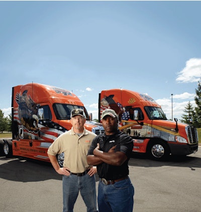 Russ O’Dell, left, and Greg Roberts are 20-year Army veterans who pilot the 2012 and 2011 Freightliner Ride of Pride trucks for Schneider National. The trucks travel the country appearing at events honoring our military.