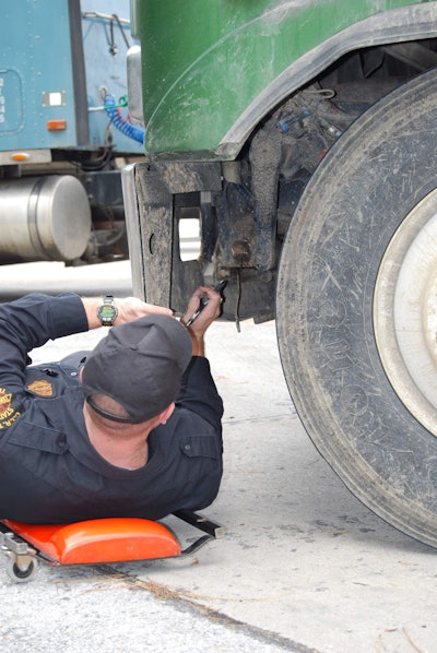 Inspector under truck