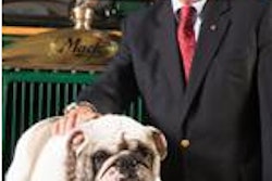 Mack’s current North American chief, Kevin Flaherty, poses with Mack the Bulldog.