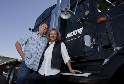 Tom and Karen brought in a net income of approximately $100,000 in 2011. Here, the driving team stands with their truck shortly after starting over-the-road in 2001. Their ’99 International 9400 has more than 1.5-million miles on it. They call the truck Butkus, named for former football player Dick Butkus.