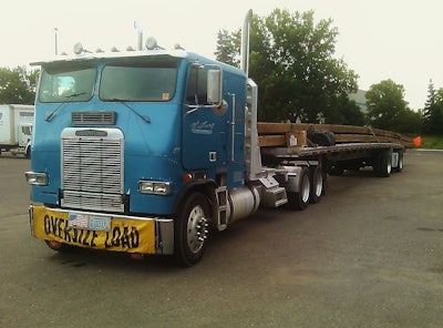 Dan Wieting was hauling 80-ft. bridge beams with his beautiful, “trusty old 1987 Freightliner” cabover “from Roseville to Tofte, Minn.,” when he sent in this picture. He added, “I hung the beam 10 feet over on the front and 22 feet over on the rear.”