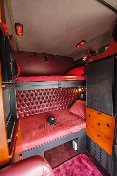 The truck’s customized interior has leather and wood grain accents from top to bottom.