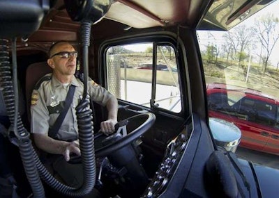 In this photo from the Chattanooga Times Free Press, Tennessee State Trooper pilots the truck used by highway patrolmen to look for motorists breaking driving laws.