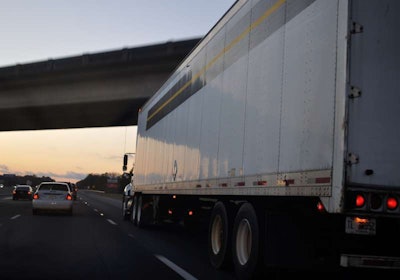 Rolling truck on highway at dusk