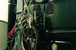Securely strapped as well as locked, Mario Almendarez’s mountain bike on the back of his tractor’s cab.