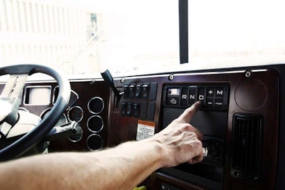 hand touching drive transmission button in truck