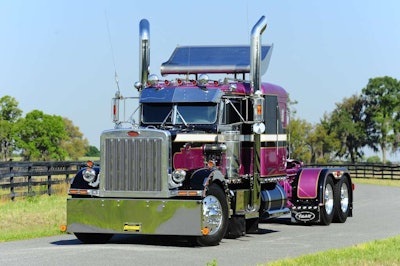Among the Pete’s unique features is the differing color treatment on the hood, cab and sleeper roofs, which unlike most striped-up rigs don’t match. While the hood is base black, the roofs above the cab and sleeper are purple – the dark metallic violet Ronnie Adams and company chose for the Adams Motor Express flagship rig.