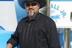 Bill Hall, Jr., standing with one of his show trucks, El Patron.
