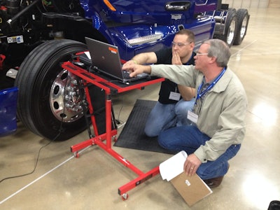 Brian Smith, from Rush Truck Center – Austin, and Peterbilt’s Wade Walterscheid troubleshoot a Paccar MX engine with the aid of diagnostic software.
