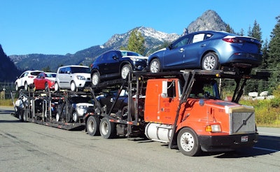 This car hauler is shown on “Snoqualmie Pass,” out in Washington State, say Andrew Luedtke, where the operator was “getting used to the new cars.”