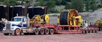 Double Diamond Transport of North Dakota runs these rigs, the first an 11-axle heavy haul 2007 Kenworth with 2013 Kalyn Lowboy “loaded with a 100-ton crane. The second is a 10-axle setup hauling a coil in the Badlands grossing 150,000 lbs. The 2003 Kenworth is powered by a Cat 6NZ with an 18-speed transmission. Double Diamond specializes in moving heavy equipment for the oilfield.