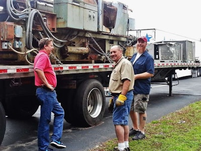 Left to right: Steve Bailey sees to it that Gerald Paquette and George Parker secure things properly.