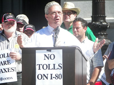 Then Pennsylvania Congresman John Peterson, flanked by owner-operators and others, in a rally against I-80 toll plans in Pennsylvania several years back. Find past coverage of the issue on Channel 19 here.
