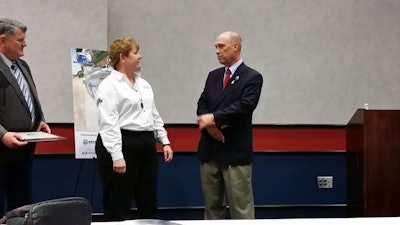 Linda Caffee, driver for FedEx Freight and well known in other circles as a member of the Trucking Solutions Group and blogger for Freightliner’s Team Run Smart, accepts her award for being named a 2014 Outstanding Trucker Buddy from Randy Schwartzenburg, president of Trucker Buddy.