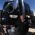 NASCAR’s Director of Transportation, Buster Auton, poses with one of the NASCAR haulers and the low-viscosity Mobil Delvac 1 LE 5W-30, which NASCAR recently began using in its 65-truck fleet.