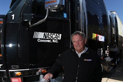NASCAR’s Director of Transportation, Buster Auton, poses with one of the NASCAR haulers and the low-viscosity Mobil Delvac 1 LE 5W-30, which NASCAR recently began using in its 65-truck fleet.