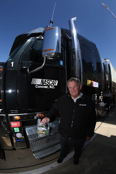 NASCAR’s Director of Transportation, Buster Auton, poses with one of the NASCAR haulers and the low-viscosity Mobil Delvac 1 LE 5W-30, which NASCAR recently began using in its 65-truck fleet.