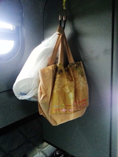 Bottled water stored in a wine bottle bag hangs nicely and doesn’t rattle around or take up tons of cabinet space.