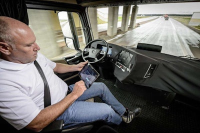 From Daimler’s self-driving truck reveal: A driver taking care of other tasks on his iPad while his truck drives itself down the highway.
