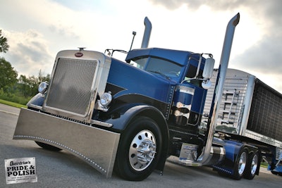 Brian Davisā 2005 Peterbilt 379 and 2012 Wilson trailer, which Anna posed with at the Great American Trucking Show.