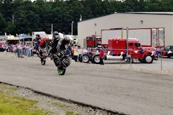 Jessie Toler and fellow rider mid-stoppie