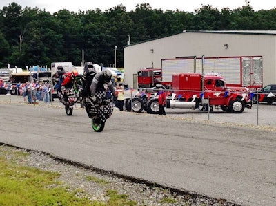Jessie Toler and fellow rider mid-stoppie
