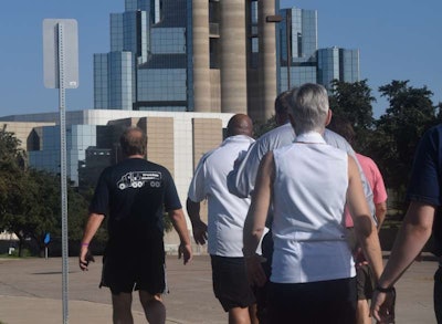 Operator Jeff Clark (left) led the way toward Daley Plaza and the site of the John F. Kennedy assassination, the turnaround point for this year’s walk.