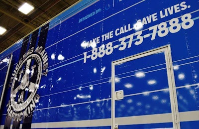 TAT’s national hotline, which feeds tips from truckers on sex trafficking to local and national law enforcement, has been the lynchpin of the organization’s efforts from its inception several years ago, a story told in Overdrive‘s April cover story following owner-operator Matt Hopkins’ February climb of Mt. Aconcagua in Argentina, done in part to spur further awareness of the organization. For the wrap on the trailer, the Colorado-based nonprofit stayed close to home, with Denver-based Pure Brand Communication donating design services. TAT then employed Colographic to produce the wrap.